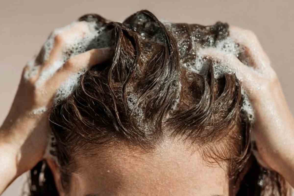 Donna che si fa lo shampoo