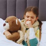 bambina con influenza e un orsetto